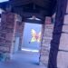 butterfly art on wall down long walkway with stone pillars in sedona arizona